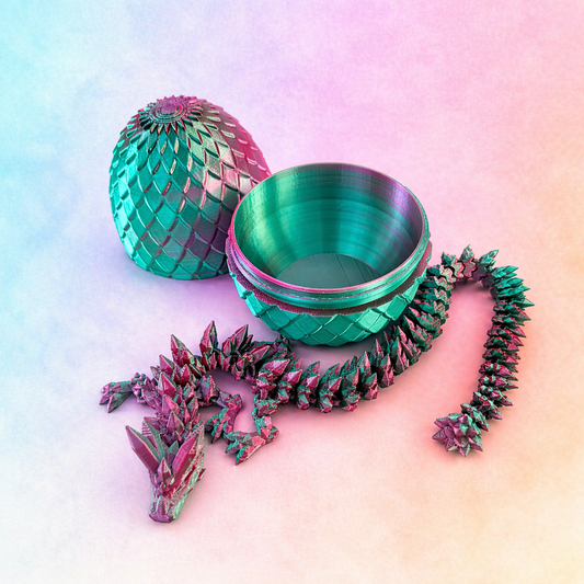 3D printed pink and green dragon with open egg and lid displayed on soft gradient background