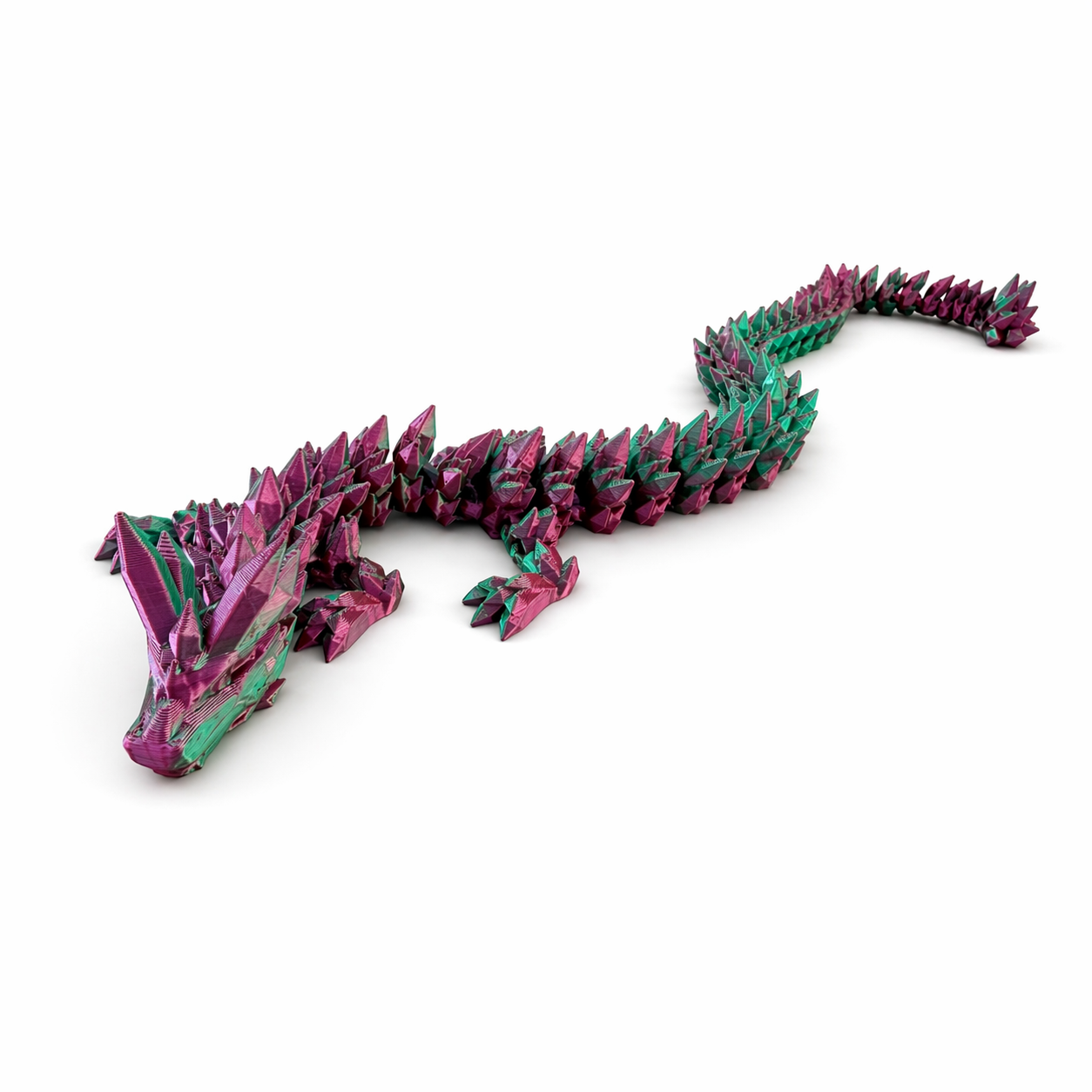Fully extended articulated dragon toy in pink and green showing flexible body and detailed design