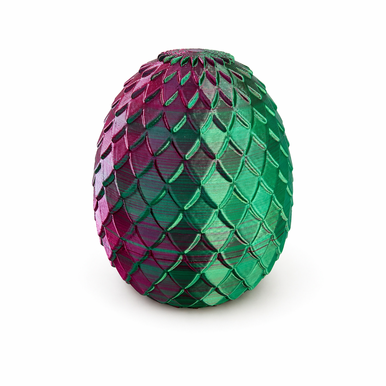 Closed 3D printed dragon egg in pink and green with scale texture design