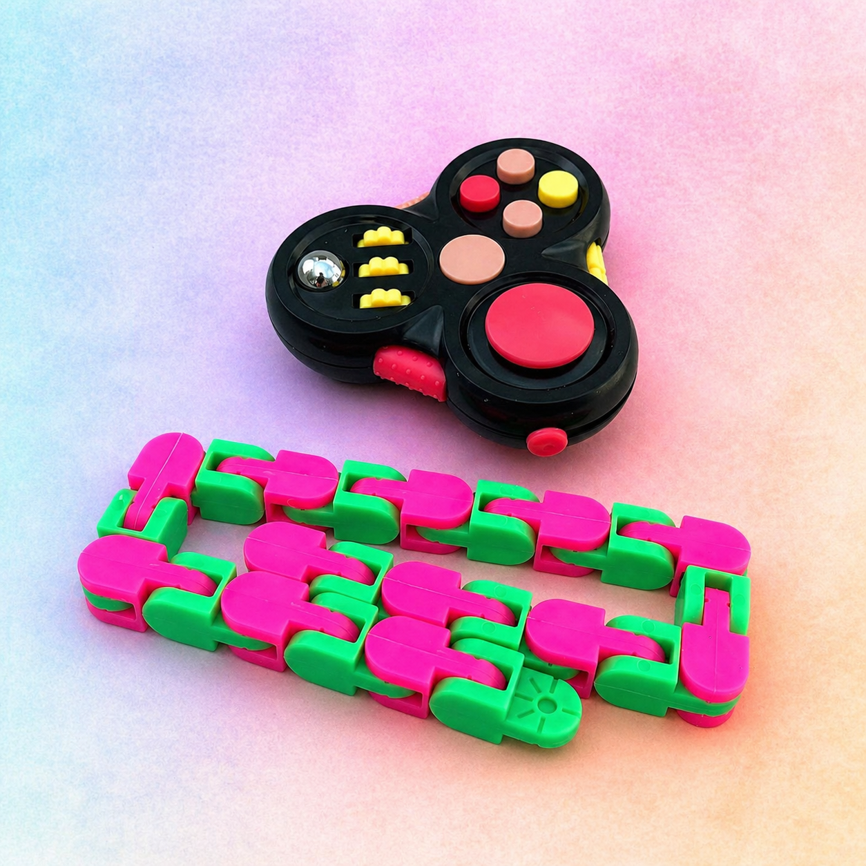 Clicker spinner and snake fidget toy bundle on pastel background showing colourful multi-function fidget and flexible chain design