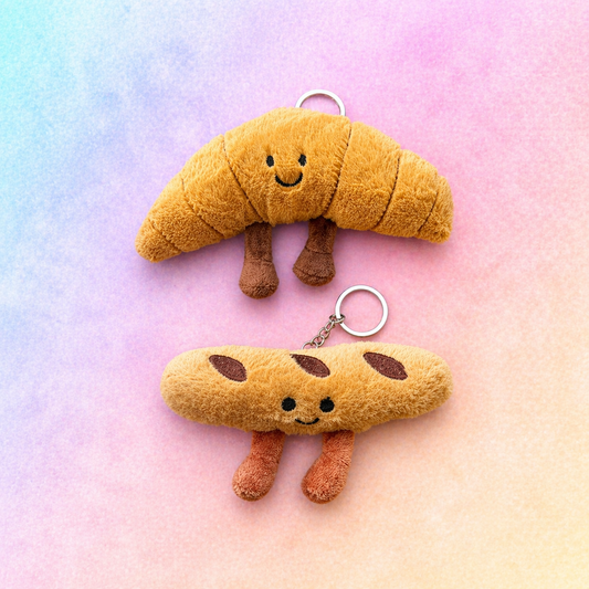 Croissant and baguette plush keyring bundle displayed together on pastel gradient background