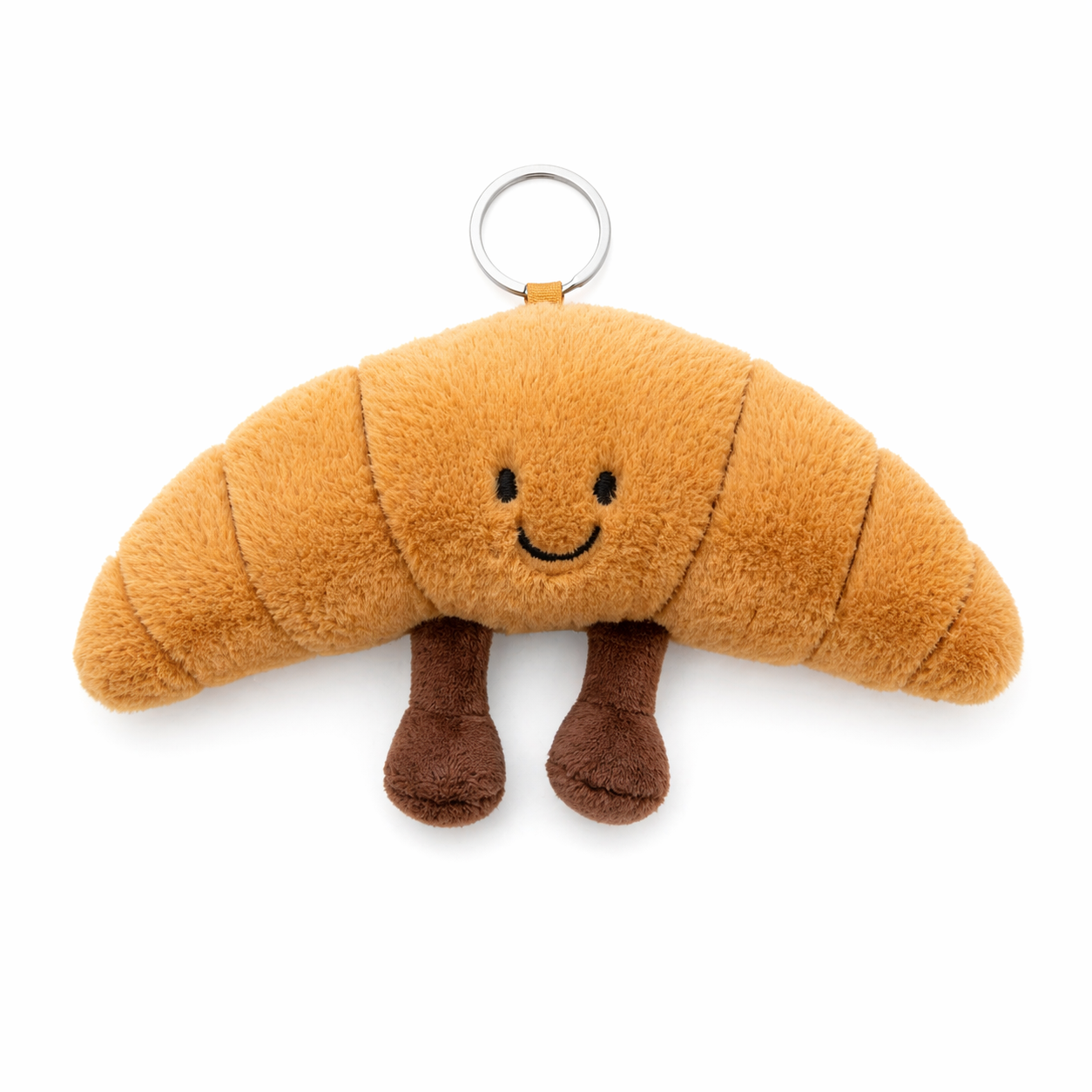 Plush croissant keyring with embroidered smiling face and soft fluffy fabric